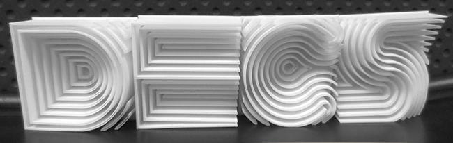 3D-printed letters spelling "DECS"